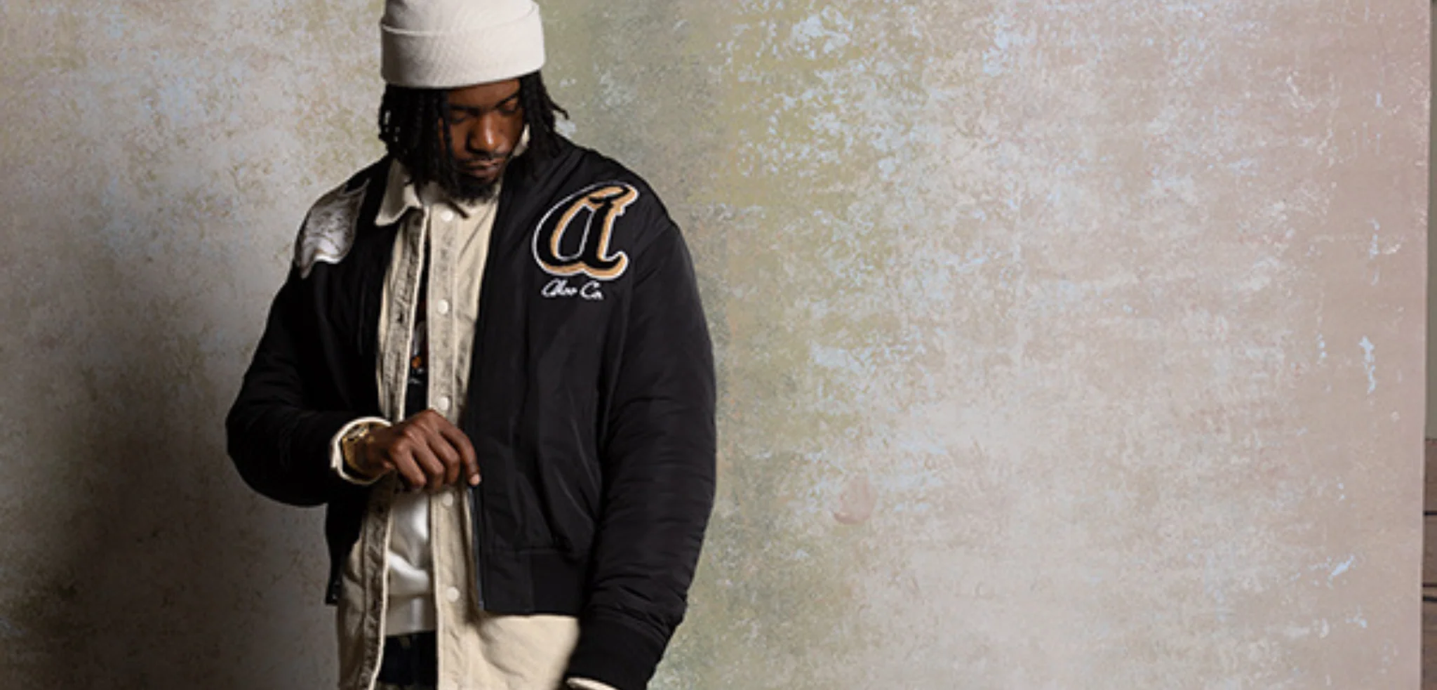 AKOO varsity jacket with leather sleeves and embroidered patches alongside AKOO bomber jacket and streetwear shorts