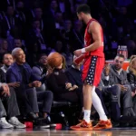 Barack Obama catches a loose basketball courtside at the 2026 NBA All-Star Game to protect Michelle Obama.