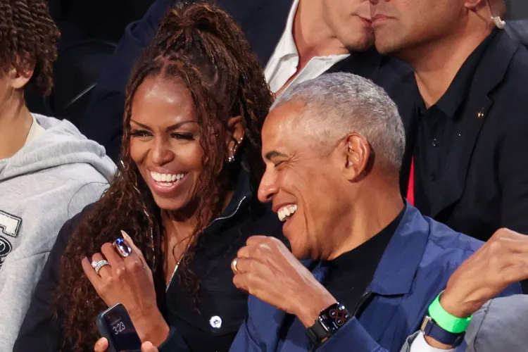Close-up of Michelle Obama in a navy Jean Paul Gaultier denim jacket with braids at the NBA All-Star Game.