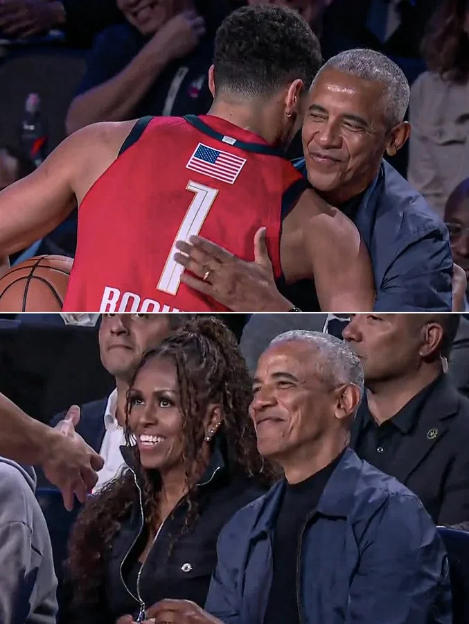 Barack, Michelle, and Sasha Obama laughing and cheering from their courtside seats at the Intuit Dome.